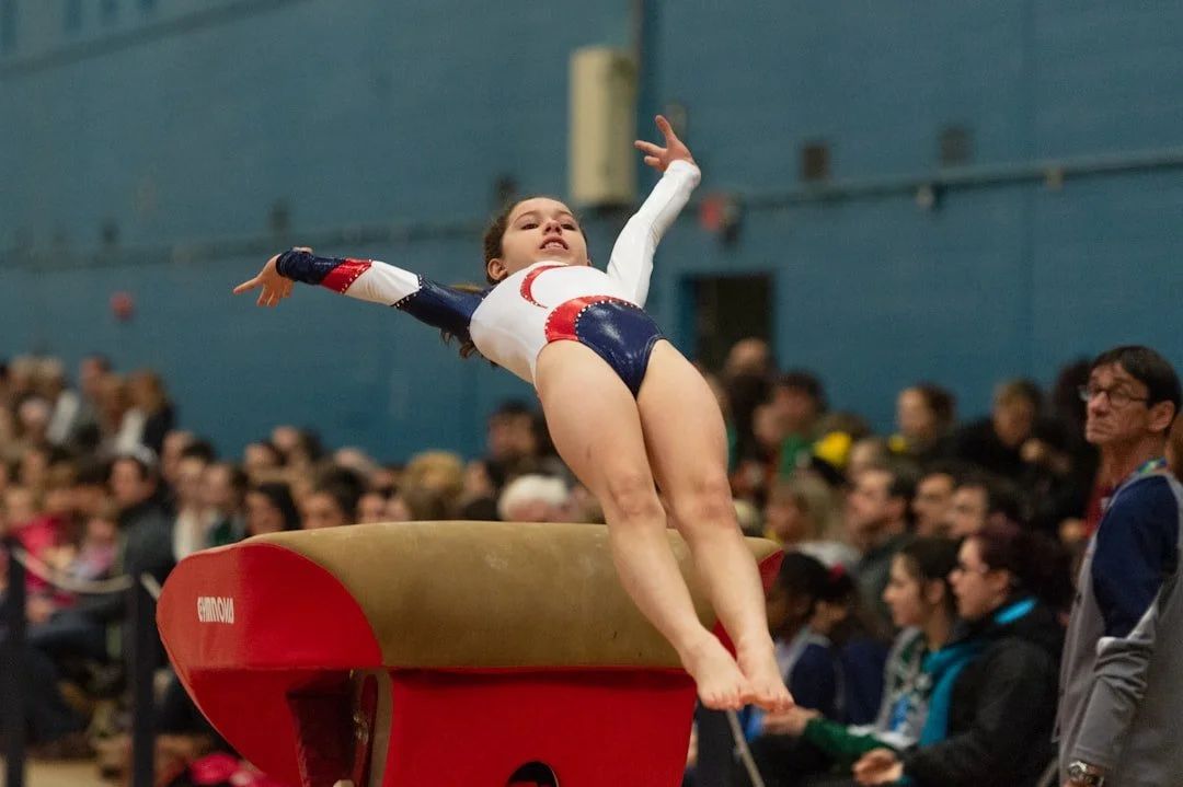 Gymnast flying off the vault table in competition