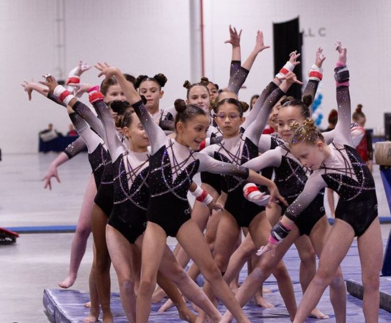 JLF Elite team gymnasts performing their floor routine in competition
