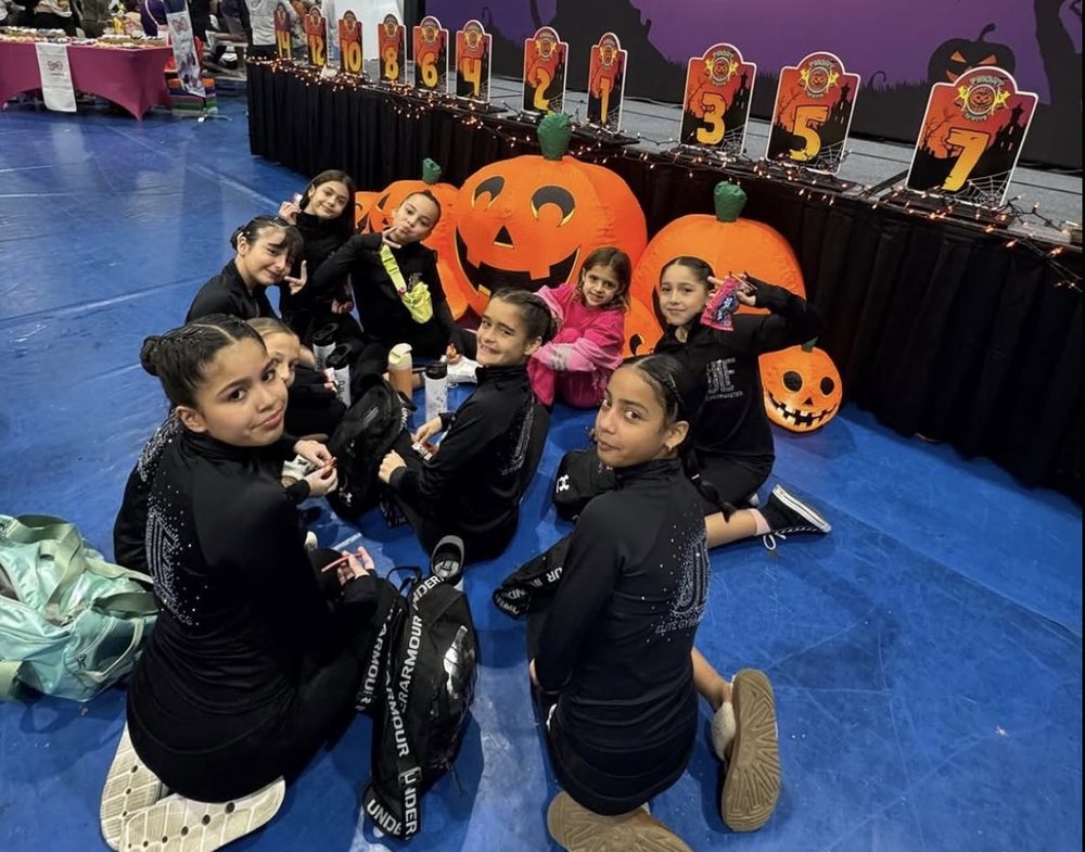 JLF Elite team members in warm-ups beside the awards podium at the Fright Invite