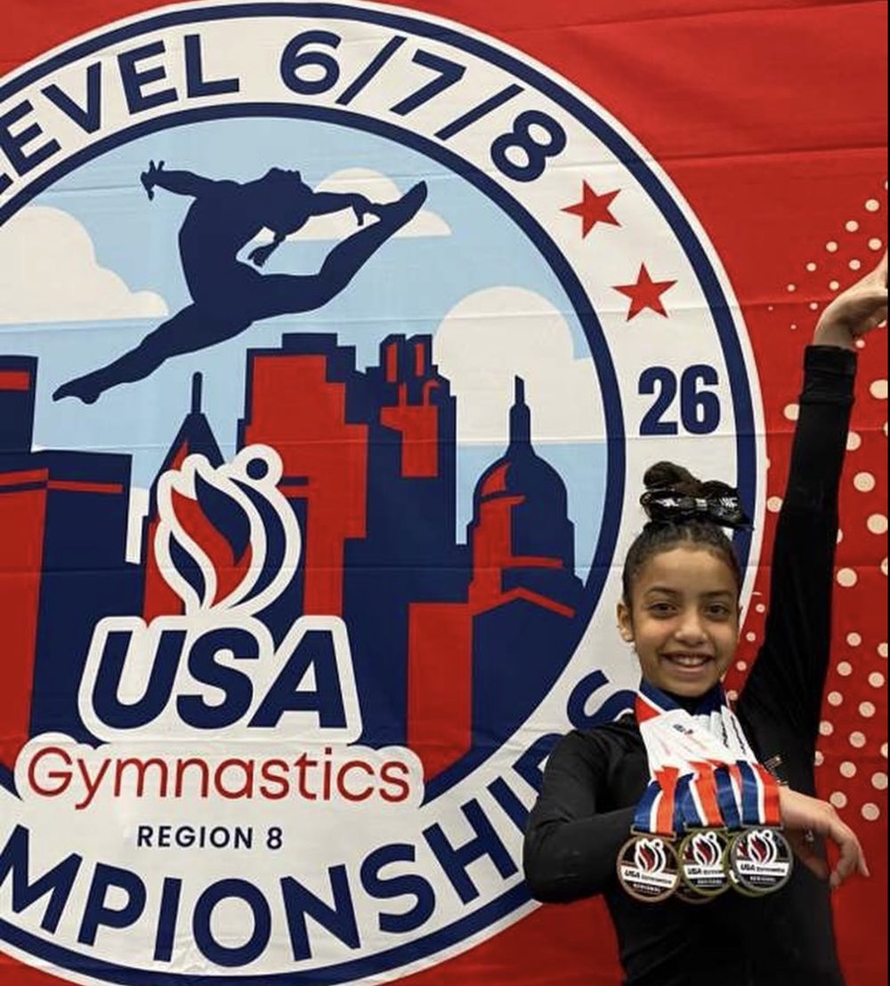 JLF Elite gymnast holding three medals at the 2026 USA Gymnastics Region 8 Level 6/7/8 Championships