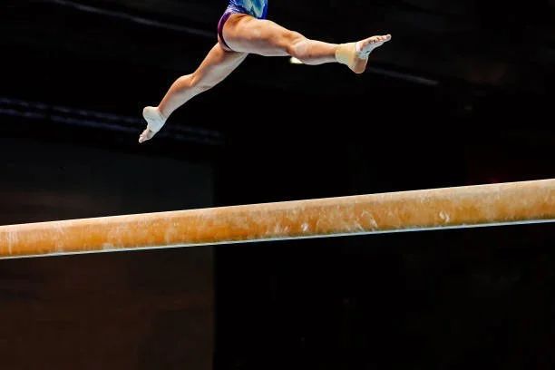 Gymnast leaping on the balance beam
